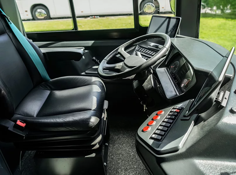 Intercity bus dashboard equipped with a video surveillance system monitor. steering wheel and dashboard panel of electric bus