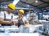 Factory workers checking quality of products in large warehouse