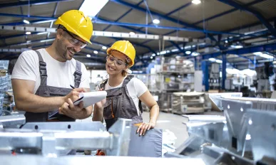 Factory workers checking quality of products in large warehouse