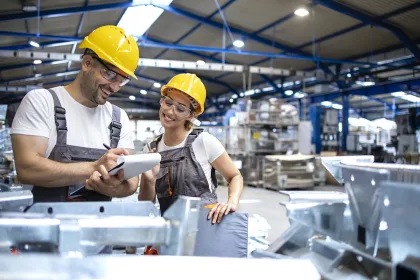 Factory workers checking quality of products in large warehouse