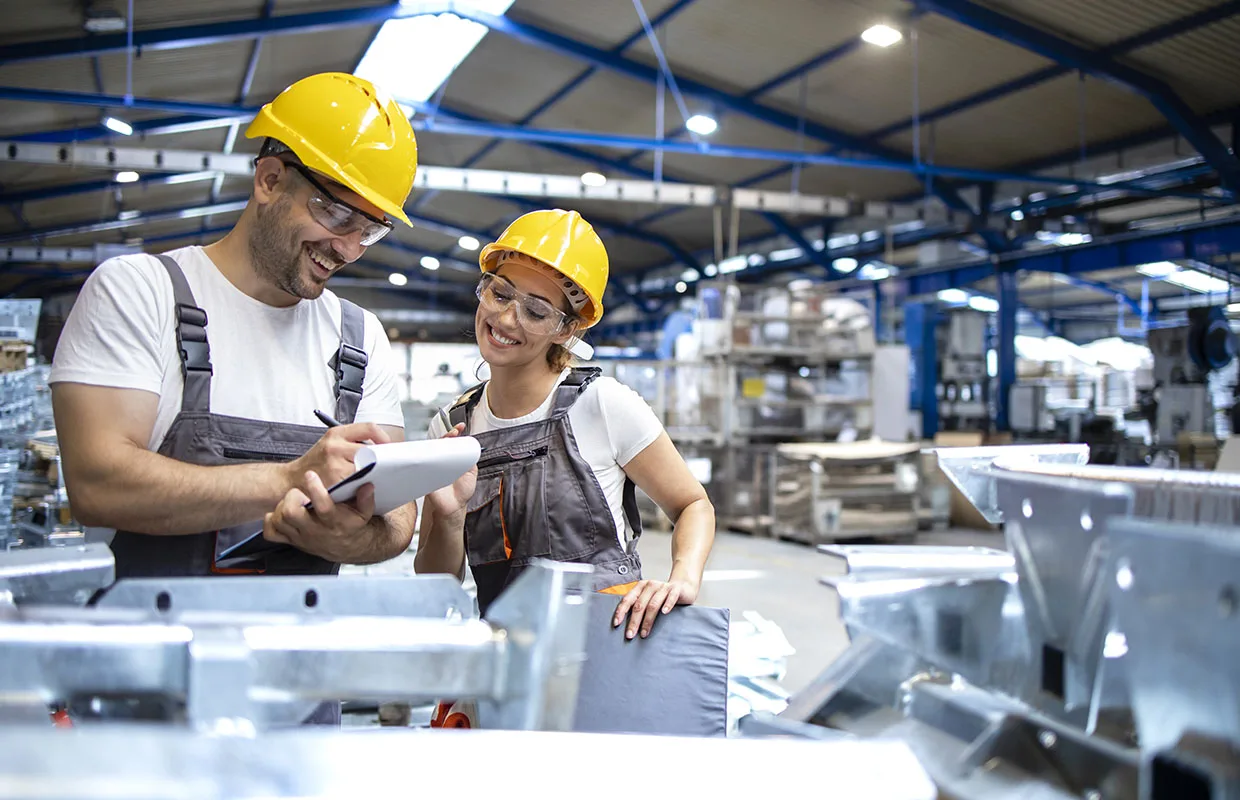 Factory workers checking quality of products in large warehouse